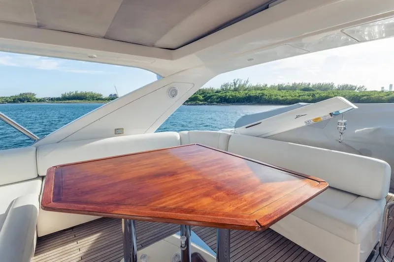 Drakkar Yacht Photos Pics Luxurious 2012 Azimut Evolution yacht interior with wooden table and scenic ocean view.