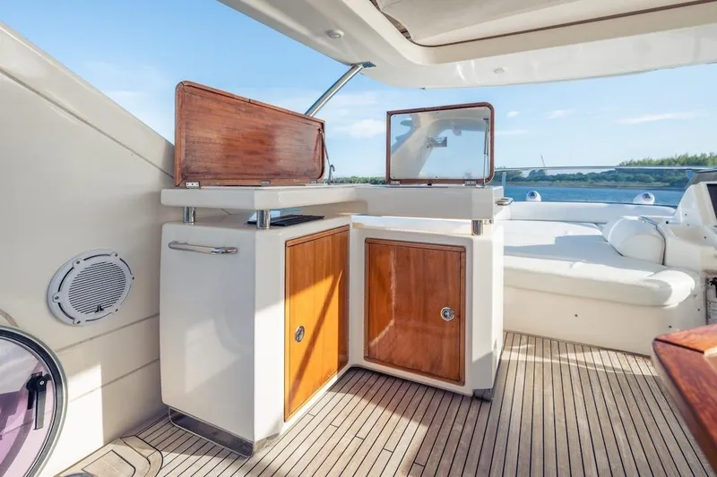 Drakkar Yacht Photos Pics Luxurious 2012 Azimut Evolution yacht interior with wooden cabinetry and scenic water view.