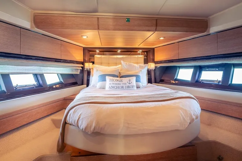 Drakkar Yacht Photos Pics Luxurious bedroom interior of 2012 Azimut Evolution yacht with elegant bedding and natural light.
