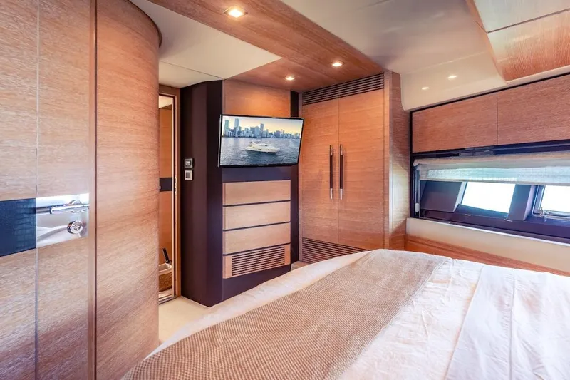 Drakkar Yacht Photos Pics Luxurious 2012 Azimut Evolution yacht bedroom with modern wood finishes and a scenic window view.