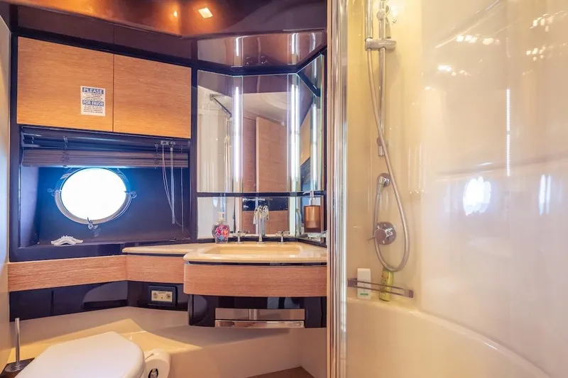 Drakkar Yacht Photos Pics Luxurious 2012 Azimut Evolution yacht bathroom with modern fixtures and porthole window.