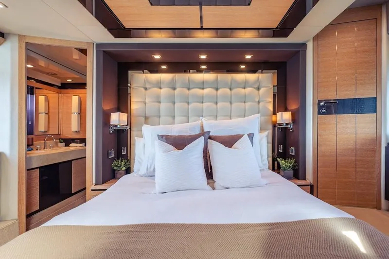 Drakkar Yacht Photos Pics Luxurious bedroom interior on 2012 Azimut Evolution yacht, featuring elegant decor and plush bedding.