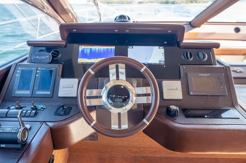 Drakkar Yacht Photos Pics Steering wheel and dashboard of 2012 Azimut Evolution yacht with navigation displays.