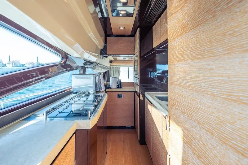 Drakkar Yacht Photos Pics Luxurious kitchen interior of 2012 Azimut Evolution yacht with modern appliances and wood finishes.