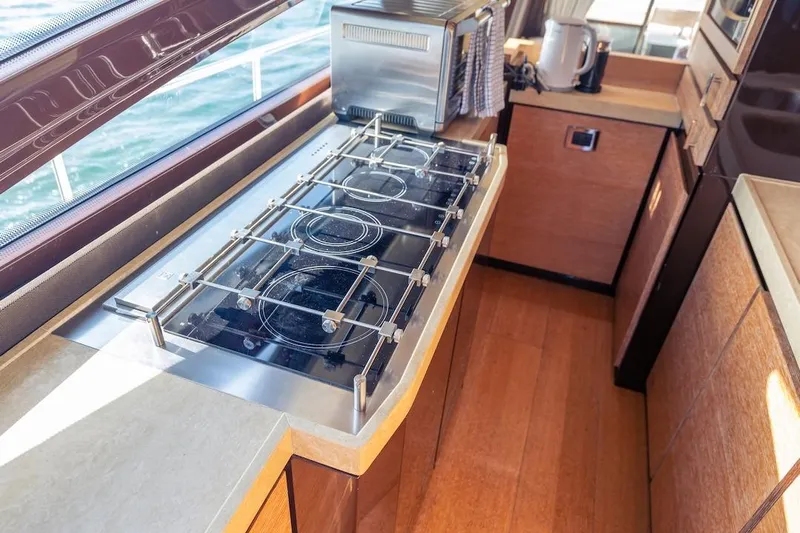 Drakkar Yacht Photos Pics Modern kitchen on 2012 Azimut Evolution yacht with stove and appliances.