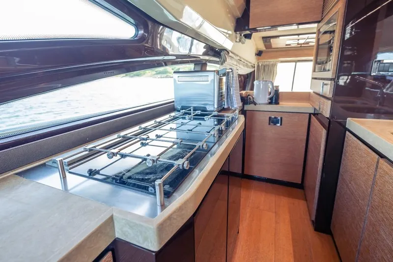 Drakkar Yacht Photos Pics Luxurious kitchen interior of 2012 Azimut Evolution yacht with modern appliances and sleek design.