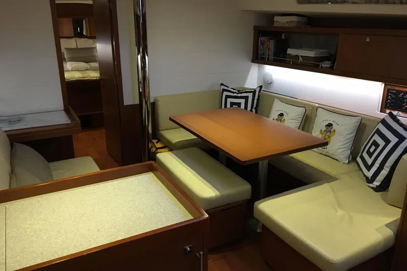 Portofolio Yacht Photos Pics Interior of 2013 Beneteau Oceanis 45 yacht with cozy seating and dining area.