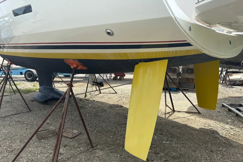 Statira Yacht Photos Pics 2017 Jeanneau Sun Odyssey 389 sailboat on stands, featuring yellow rudders.