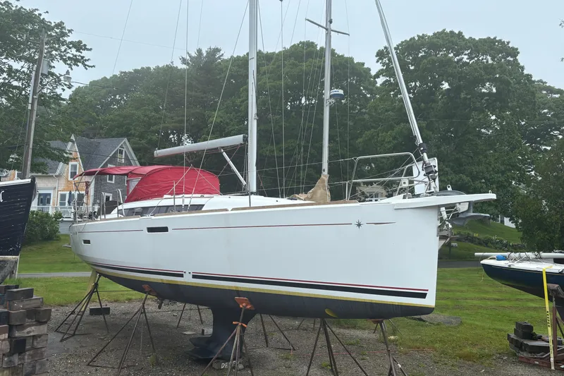 Statira Yacht Photos Pics 2017 Jeanneau Sun Odyssey 389 sailboat on stands, surrounded by greenery and houses.