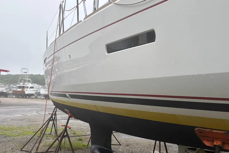 Statira Yacht Photos Pics 2017 Jeanneau Sun Odyssey 389 sailboat on stands, side view in a boatyard.