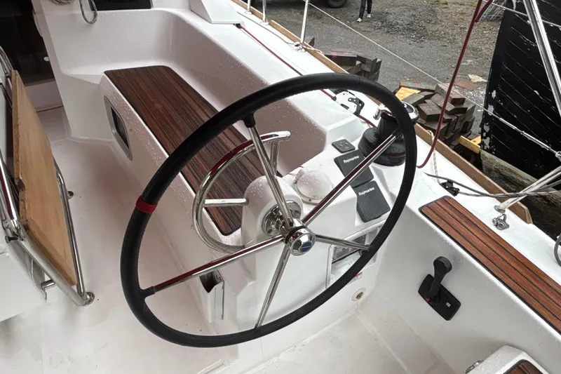 Statira Yacht Photos Pics Steering wheel of 2017 Jeanneau Sun Odyssey 389 sailboat, featuring teak accents and navigation controls.