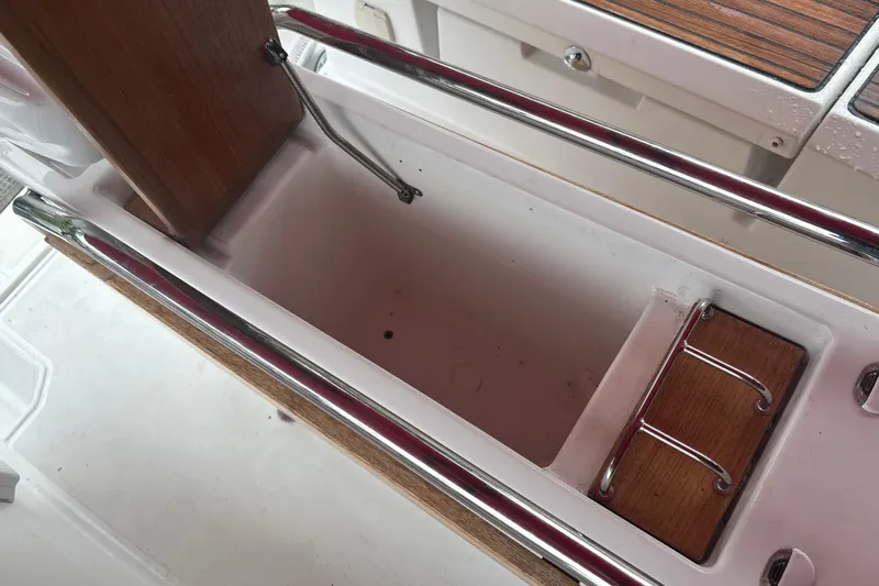 Statira Yacht Photos Pics Storage compartment on 2017 Jeanneau Sun Odyssey 389 sailboat, featuring wood and metal details.