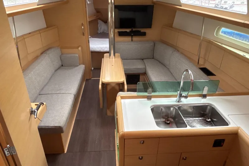 Statira Yacht Photos Pics Interior of 2017 Jeanneau Sun Odyssey 389 yacht with modern kitchen and cozy seating area.