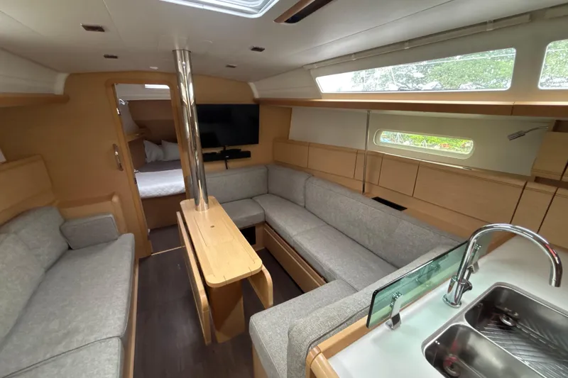 Statira Yacht Photos Pics Interior of 2017 Jeanneau Sun Odyssey 389 yacht with modern seating and kitchenette.