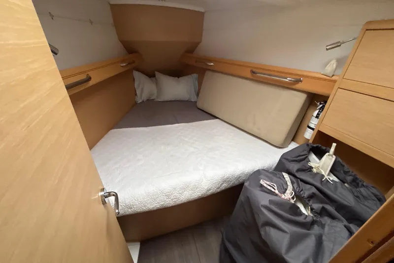 Statira Yacht Photos Pics 2017 Jeanneau Sun Odyssey 389 cabin interior with bed, storage, and wooden finish.