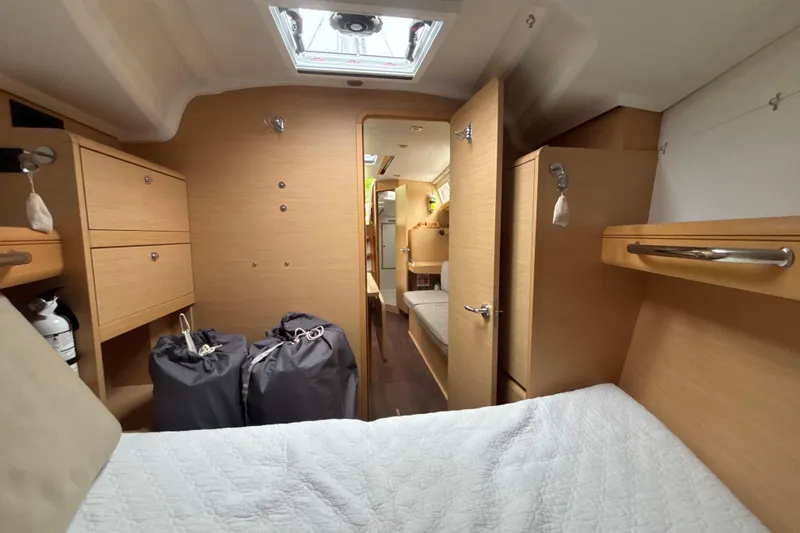 Statira Yacht Photos Pics 2017 Jeanneau Sun Odyssey 389 interior cabin with wood finish and storage compartments.