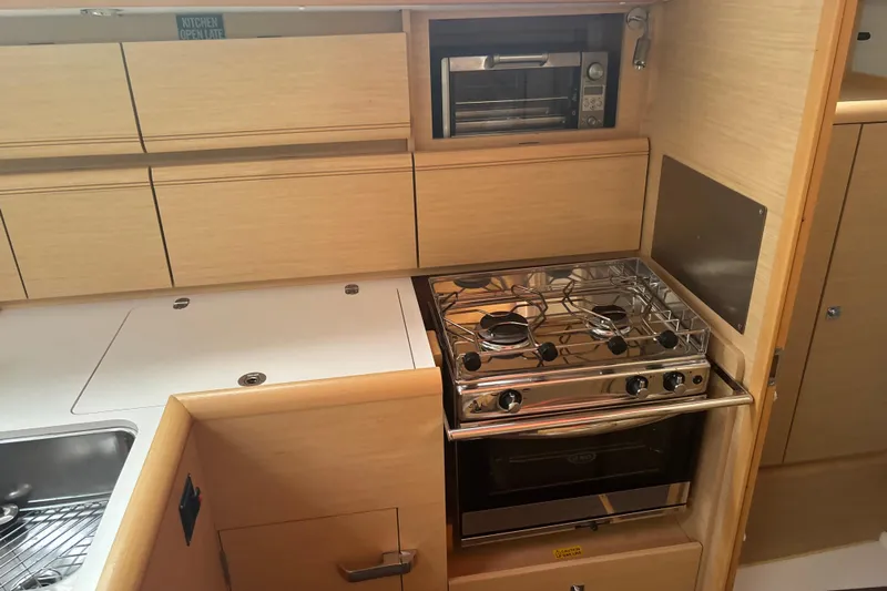 Statira Yacht Photos Pics Modern kitchen in 2017 Jeanneau Sun Odyssey 389 yacht with stove and oven.