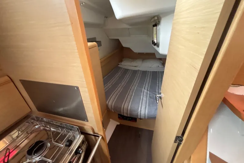 Statira Yacht Photos Pics Cozy cabin interior of 2017 Jeanneau Sun Odyssey 389 sailboat with bed and compact kitchen.