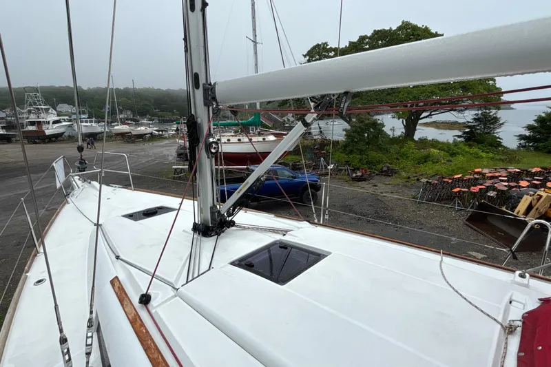 Statira Yacht Photos Pics 2017 Jeanneau Sun Odyssey 389 sailboat on land, surrounded by trees and other boats.