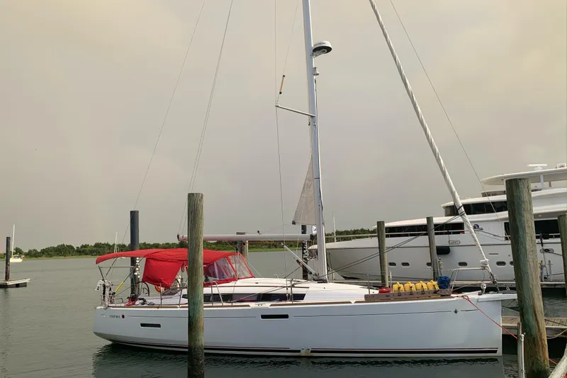 Statira Yacht Photos Pics 2017 Jeanneau Sun Odyssey 389 sailboat docked with red canopy.