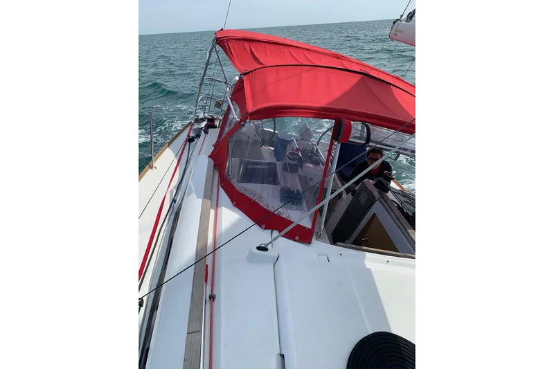 Statira Yacht Photos Pics 2017 Jeanneau Sun Odyssey 389 sailing with red canopy on open sea.
