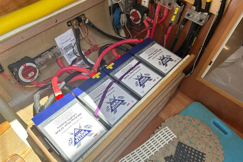 Statira Yacht Photos Pics Battery compartment of a 2017 Jeanneau Sun Odyssey 389 sailboat, showing wiring and connections.