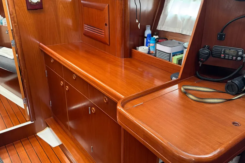 Sea Escape Yacht Photos Pics Interior of 2003 Beneteau 393 sailboat with wooden cabinetry and navigation equipment.