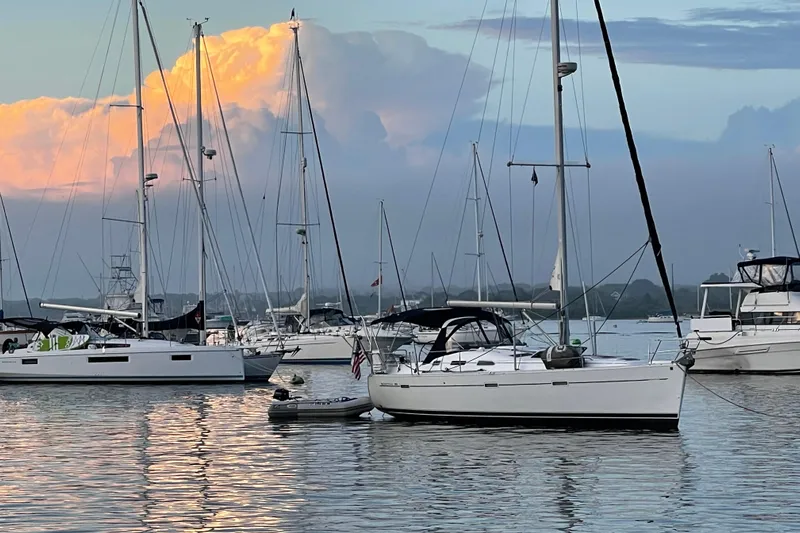 Sea Escape Yacht Photos Pics Sailboats anchored at sunset, featuring a 2003 Beneteau 393 model.
