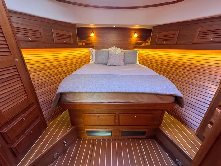  Yacht Photos Pics Luxurious cabin interior of 2019 Sabre 42 Salon Express with warm wood paneling and ambient lighting.