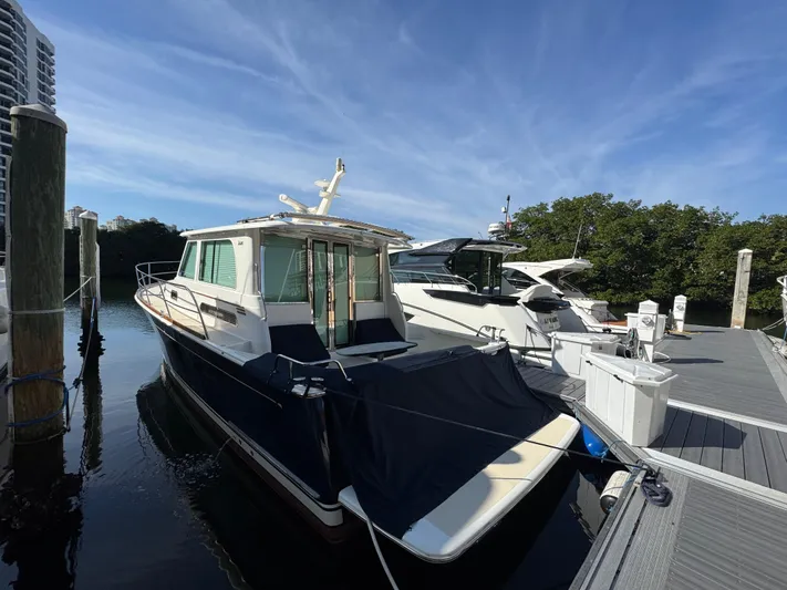  Yacht Photos Pics 2019 Sabre 42 Salon Express docked at marina under clear blue sky.