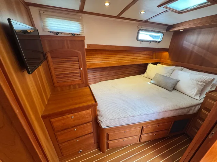  Yacht Photos Pics Luxurious 2019 Sabre 42 Salon Express cabin with wood finish and cozy bed.