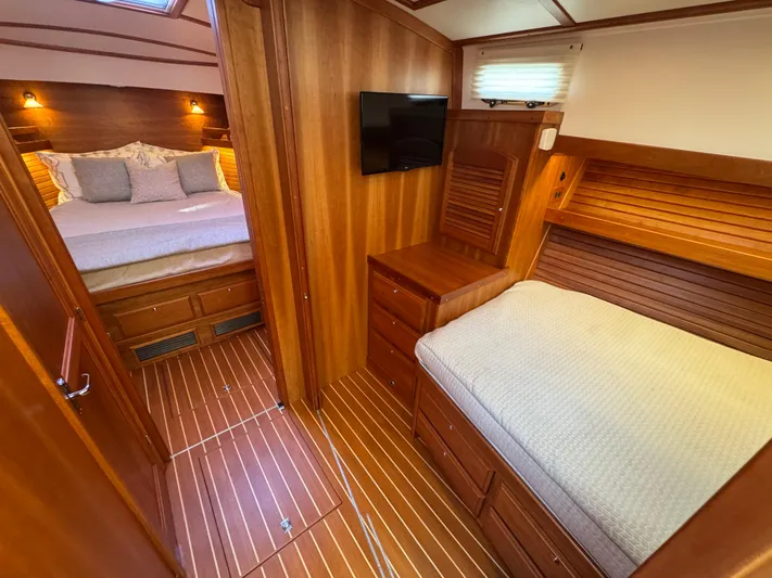  Yacht Photos Pics 2019 Sabre 42 Salon Express interior with wooden finish, twin beds, and wall-mounted TV.