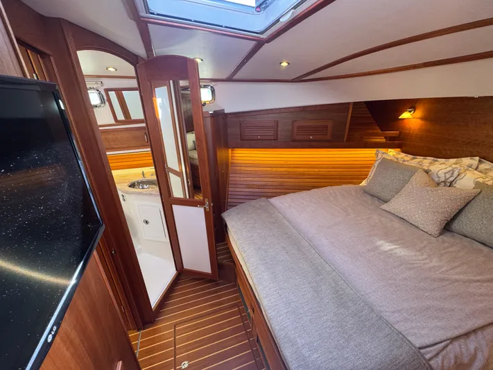  Yacht Photos Pics Luxurious 2019 Sabre 42 Salon Express cabin with cozy bed and elegant wood finish.