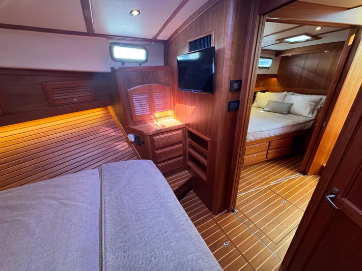  Yacht Photos Pics 2019 Sabre 42 Salon Express interior with wood paneling, cozy beds, and ambient lighting.