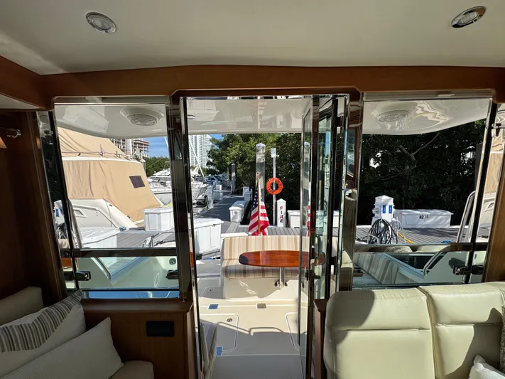  Yacht Photos Pics 2019 Sabre 42 Salon Express interior view with open doors to deck and American flag.