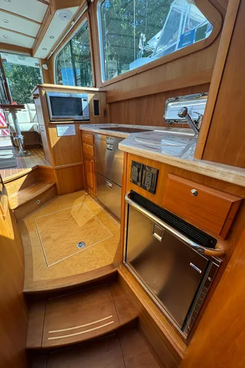  Yacht Photos Pics 2019 Sabre 42 Salon Express interior with modern kitchen and wood finish.