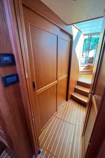  Yacht Photos Pics 2019 Sabre 42 Salon Express interior with wooden paneling and stairs leading to the deck.