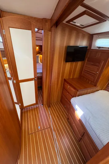  Yacht Photos Pics 2019 Sabre 42 Salon Express interior with wood paneling, bed, TV, and storage drawers.
