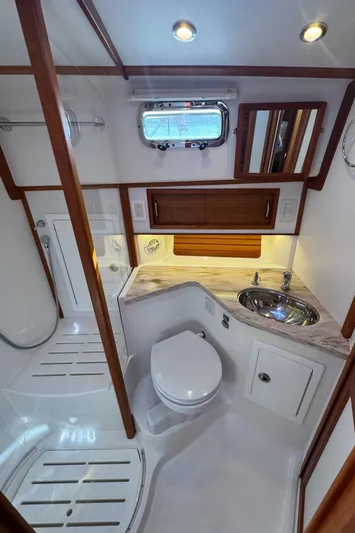  Yacht Photos Pics 2019 Sabre 42 Salon Express bathroom with modern fixtures, wooden accents, and a sleek design.