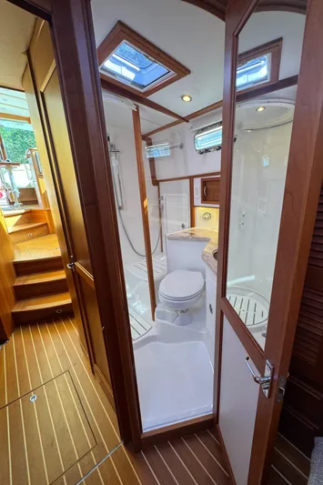  Yacht Photos Pics 2019 Sabre 42 Salon Express bathroom with wooden accents and skylights.