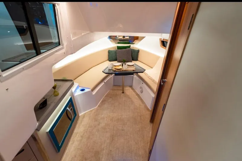  Yacht Photos Pics Luxurious interior of 2026 Granfort 37 GTX yacht with cozy seating and dining area.