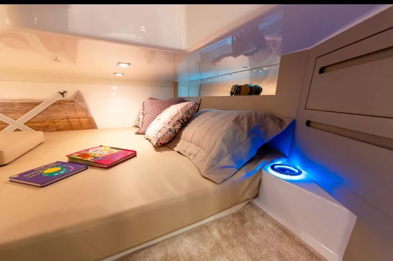  Yacht Photos Pics Luxurious cabin interior of 2026 Granfort 37 GTX yacht with cozy bedding and ambient lighting.
