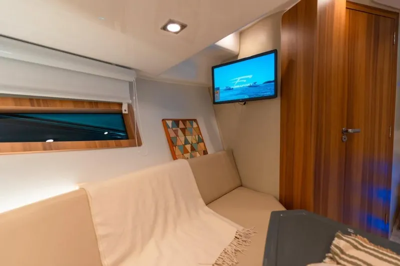  Yacht Photos Pics Interior of 2026 Granfort 37 GTX yacht with cozy seating and wall-mounted TV.