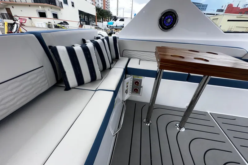  Yacht Photos Pics Luxurious seating area on 2026 Granfort 37 GTX yacht with striped cushions and wooden table.