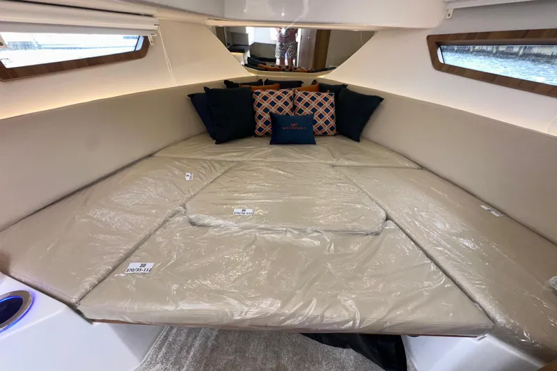  Yacht Photos Pics Interior cabin of 2026 Granfort 37 GTX yacht with cushioned seating and decorative pillows.