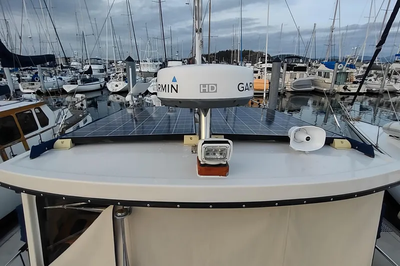 Dobro Yacht Photos Pics 1990 Nordic Tug 32 with solar panels and radar, docked in a marina.