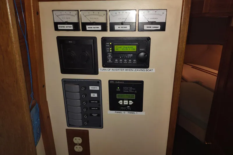 Dobro Yacht Photos Pics Electrical control panel on a 1990 Nordic Tug 32 boat, featuring gauges and switches.
