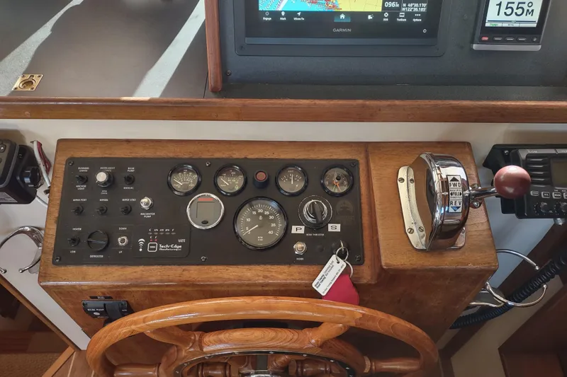 Dobro Yacht Photos Pics Control panel of a 1990 Nordic Tug 32 with gauges and navigation equipment.