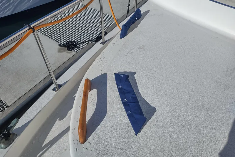 Dobro Yacht Photos Pics Deck of 1990 Nordic Tug 32 with railing and blue cover.