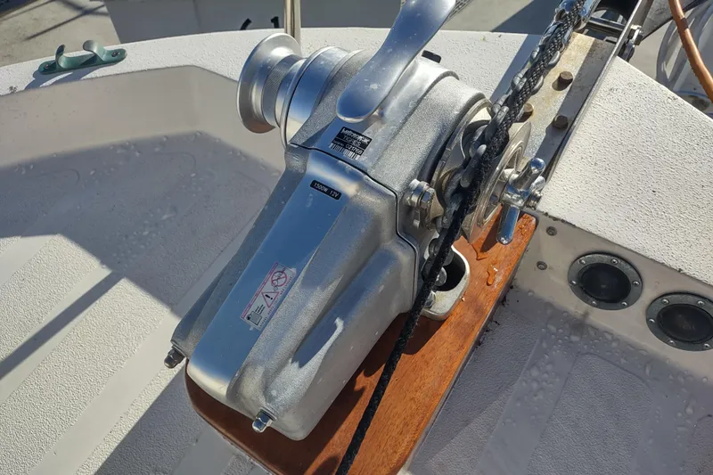 Dobro Yacht Photos Pics Anchor winch on 1990 Nordic Tug 32 boat deck, featuring chain and handle.